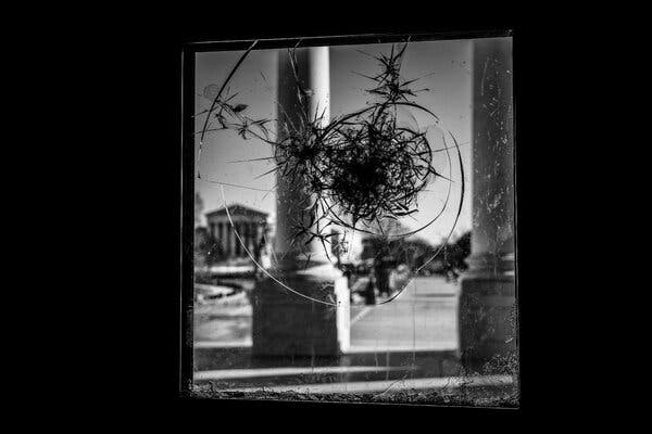 A view through a broken window at the Capitol.
